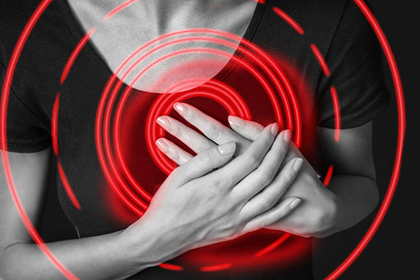 Woman is clutching her chest, heart attack stock photo