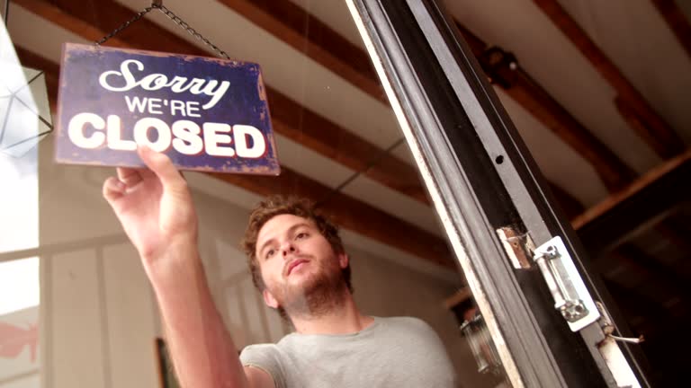 Hipster Man Turning Opening Sign on Door Coffee Shop