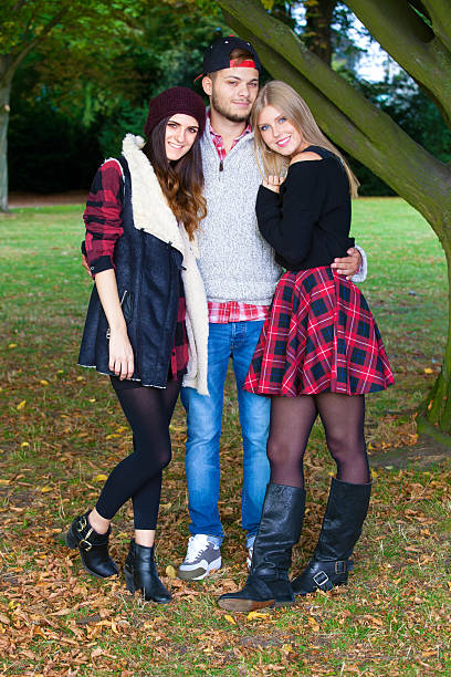 istock Young man with two girls in a park. 520117669