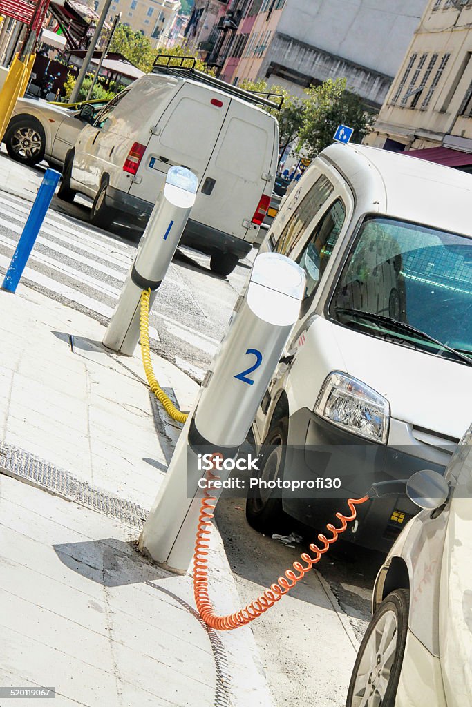Eco car parking Two Electric vehicles with plugged cable in charging station High Angle View Stock Photo