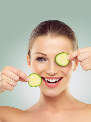 Studio portrait of a beautiful young woman posing with two cucumber slices against a green backgroundhttp://azarubaika.com/iStockphoto/2014_05_09_Victoria_Beauty.jpg