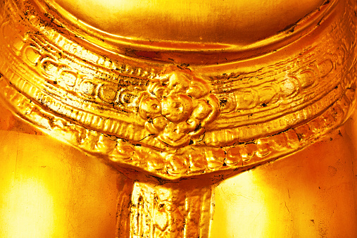 Close-up of golden belt and sash of buddha in Wat Pho, Bangkok