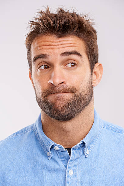 I don't know about that Studio shot of a handsome man looking uncertain against a gray background confusion raised eyebrows human face men stock pictures, royalty-free photos & images