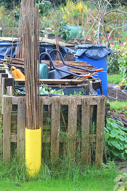 istock Wooden compost heaps, compost bin converters, allotment / vegetable garden waste 520120277