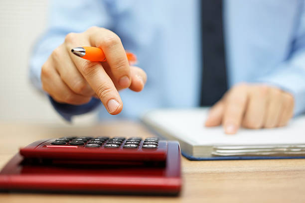 shallow depth of field of accountant calculating financial data stock photo