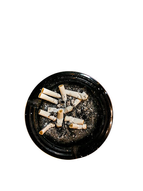 Dirty round dirty ashtray with cigarette butts and stubs extinguished stock photo