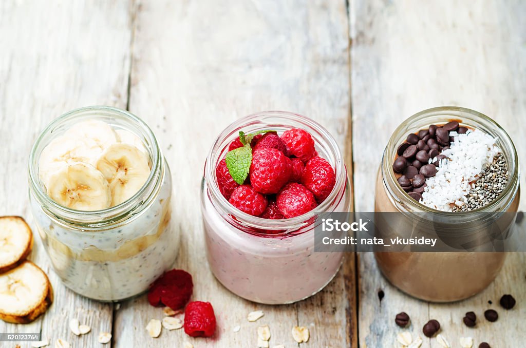 set overnight oats with berries, Chia seeds and chocolate chips set overnight oats with berries, coconut, peanut butter, Chia seeds and chocolate chips. toning. selective focus Oats - Food Stock Photo