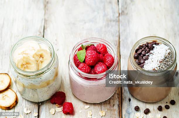 Set Overnight Oats With Berries Chia Seeds And Chocolate Chips Stock Photo - Download Image Now