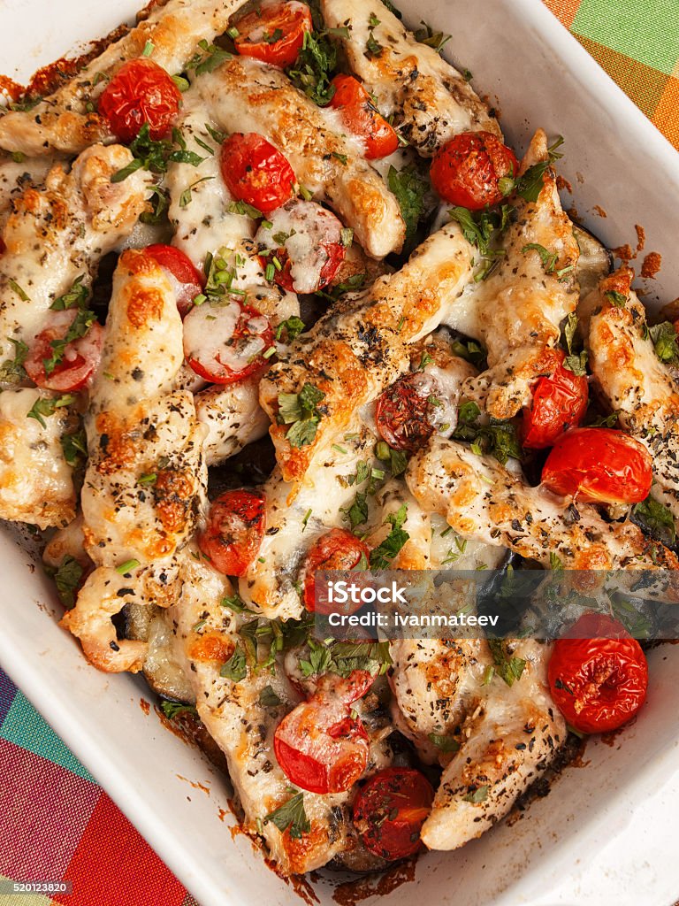 Italian chicken bake with mozzarella Italian chicken bake casserole with mozzarella, cherry tomatoes and oregano, shot from above Baked Stock Photo