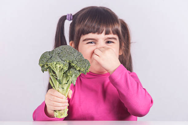 istock Little girl refusing to eat her vegetables 520125120