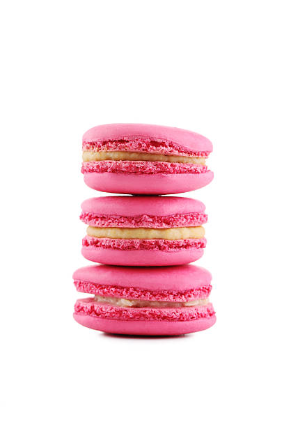 istock Tasty pink macarons isolated on white 520127432