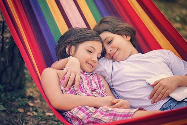 istock Beautiful Sisters Relaxing Together In The Hammock 520127550