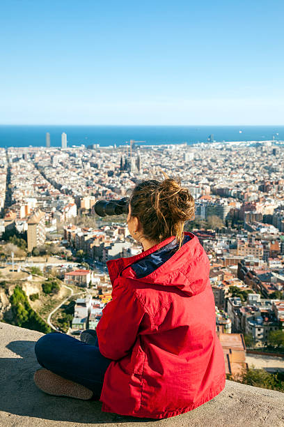 istock Young woman looking over Barcelona 520127760