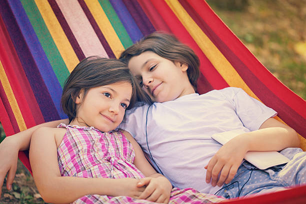 istock Beautiful Sisters Relaxing Together In The Hammock 520127896
