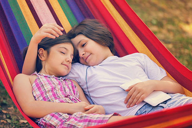 istock Beautiful Sisters Relaxing Together In The Hammock 520128334