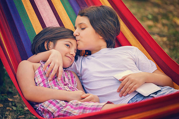 istock Beautiful Sisters Relaxing Together In The Hammock 520128594