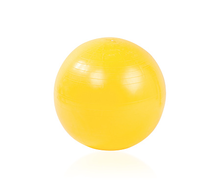 Yellow yoga exercise gym ball isolated on white