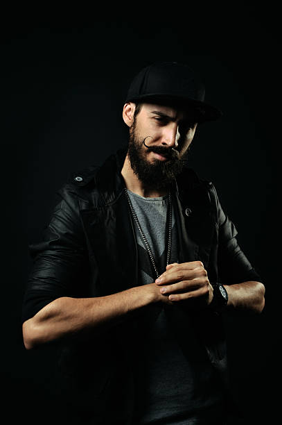 istock The bearded man in a jacket flexing his fists 520131123