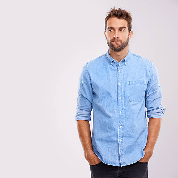 Thinking... Studio shot of a handsome male looking thoughtful worried man standing stock pictures, royalty-free photos & images