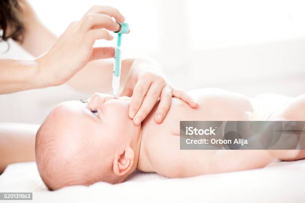 Baby Being Given Medicine Through Mouth Stock Photo - Download Image Now - Polio Vaccine, Newborn, Medicine