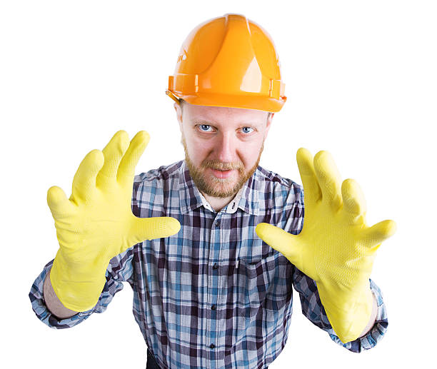istock Man in a helmet and yellow gloves 520132630