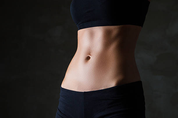 istock Slim woman's body over dark grey background 520133619