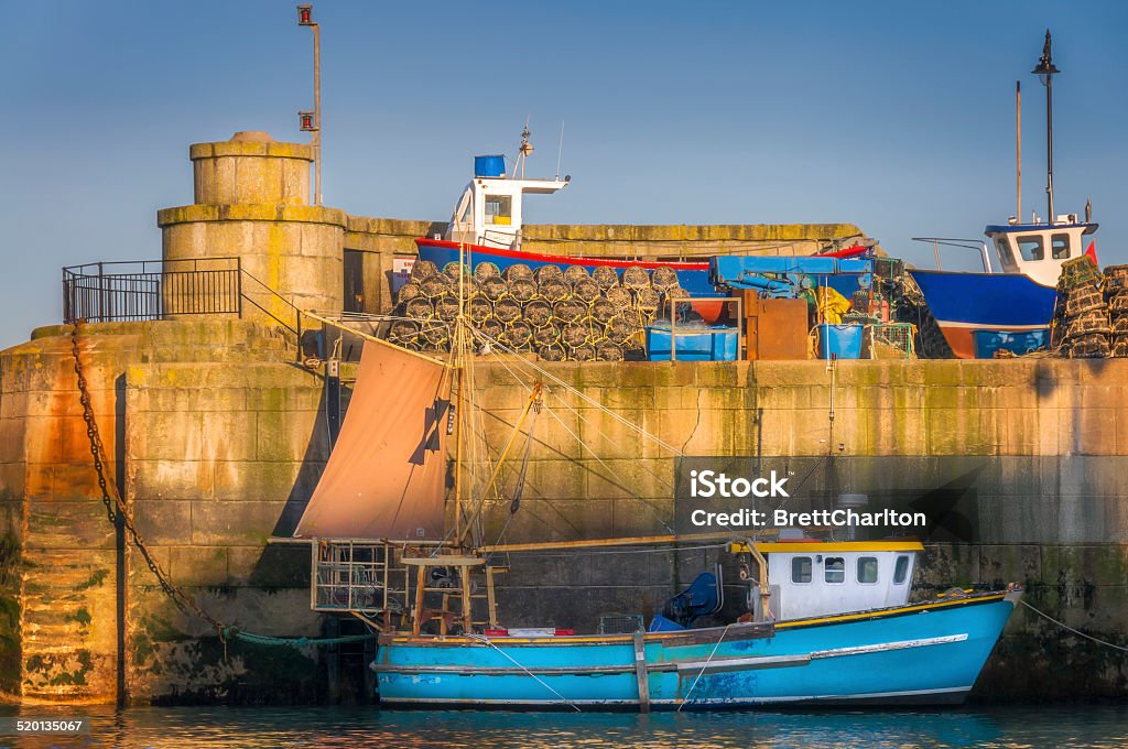 Newquay Habour Trawler moored in Torquay harbour, England. Soft sunlight from a rising sun. Fishing Stock Photo