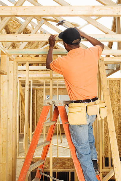 istock Young couple working at new home construction site 520135117