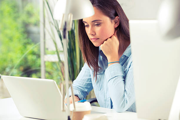 istock Businesswoman sitting at her desk with laptop computer. 520135807