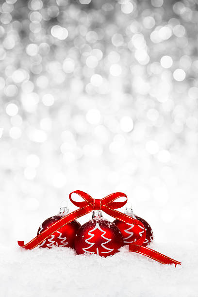 istock Red bauble with ribbon and Christmas tree decoration on snow 520135917