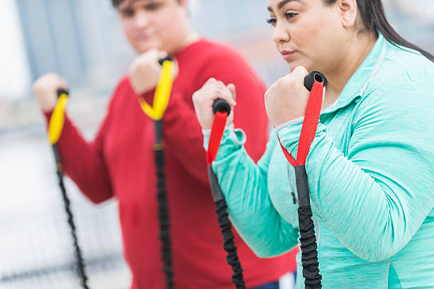 istock Hispanic woman, friend exercising with resistance bands 520136016