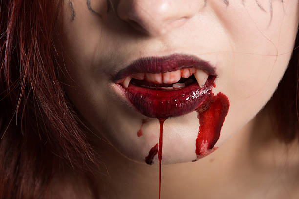 istock Vampire's bloody mouth with fangs. 520136459