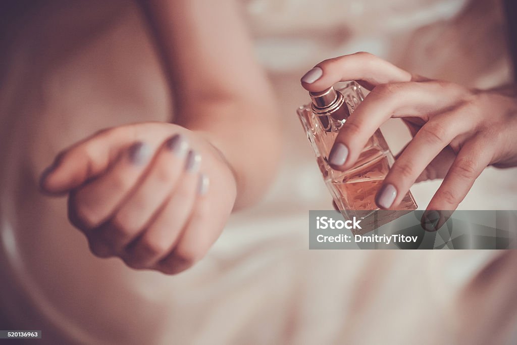 woman applying perfume on her wrist bride applying perfume on her wrist Perfume Stock Photo