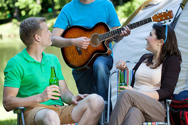 istock Couple listening to man playing guitar 520137481