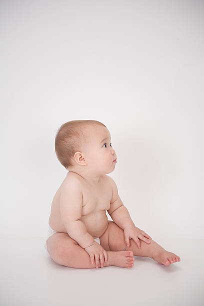 istock cute baby girl looking to side 520138093