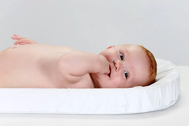 Naked baby lying on his back