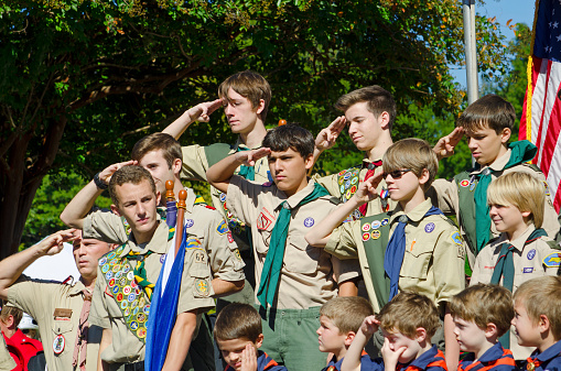 Belmont, North Carolina, USA - October 4, 2014: A group of Boy Scouts of America from Troop 62 stands at attention to North Carolina Governor, Pat McCrory during a speech dedicating a statue to honor the Veterans of World War II. The Boy Scouts of America (BSA) was founded in 1910 and has 2.7 million youth members.