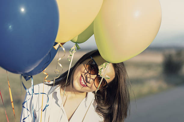 istock Woman with balloons 520166283
