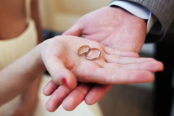 istock Hands with wedding rings on bridal bouquet 520166648