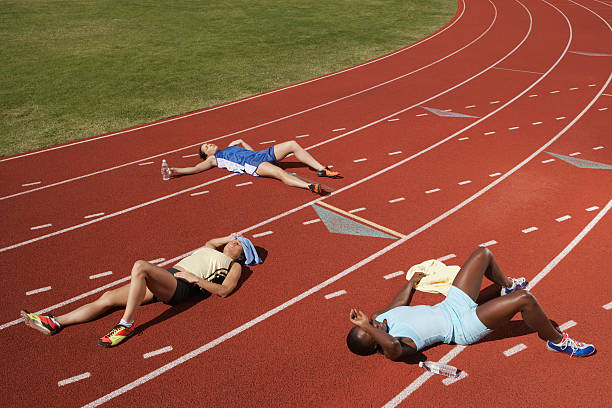 Exhausted runners on track Exhausted runners on track defeat stock pictures, royalty-free photos & images