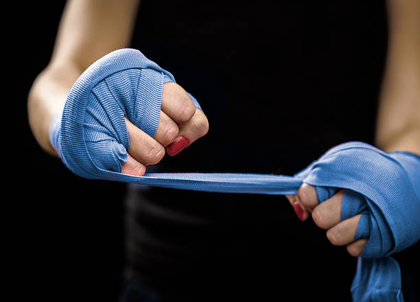 istock Woman is wrapping hands with blue boxing wraps 520167496