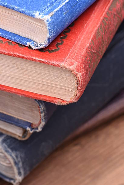 istock Stack of old books on wooden table 520167624