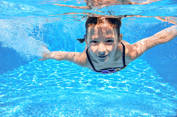 istock Happy active underwater child swims in pool 520167859