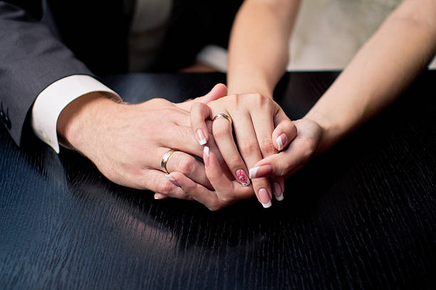 istock Hands of groom and bride with rings 520169396
