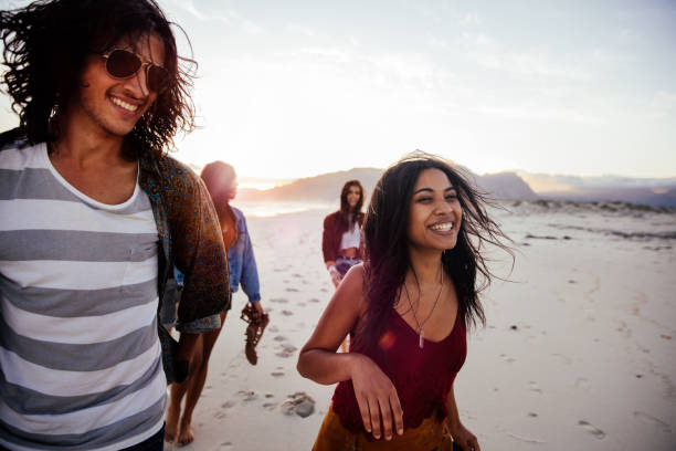 istock Happy multi-ethnic hipster friends walking on the beach 520171296