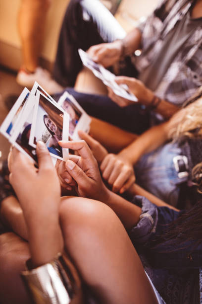 istock Group of friends looking at ploaroid instant photos in van 520173936