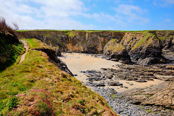 Newtrain Bay North Cornwall between Trevone and Harlyn and near Padstow and Newquay and on the South West Coast Path in spring with blue sky and sea