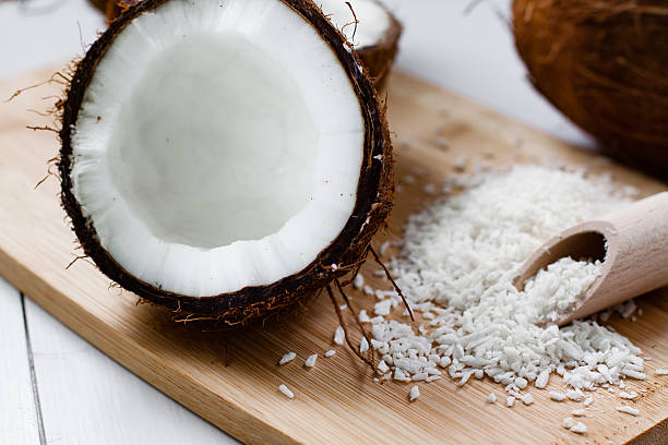 istock Whole and broken coconut with grated cocont flakes. 520176374