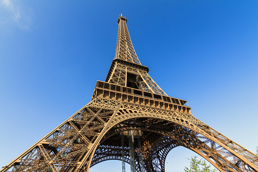 Beautiful view of the Eiffel tower seen from beneath with a blue sky in spring in Paris