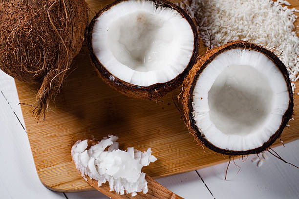 istock Whole and broken coconut with grated cocont flakes. 520177750